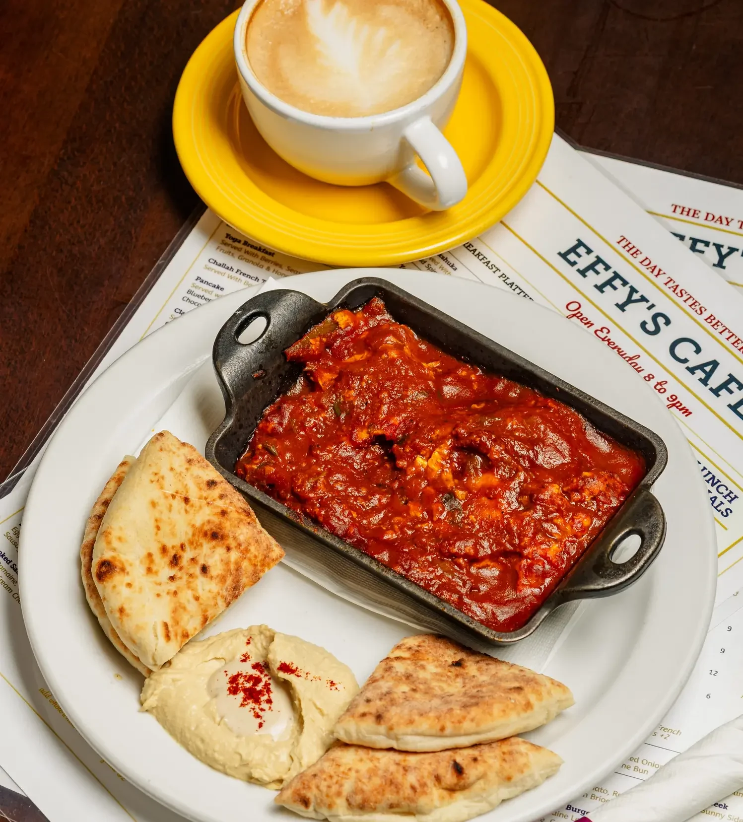 Table set for two at Effy’s Café with shakshuka and coffee.