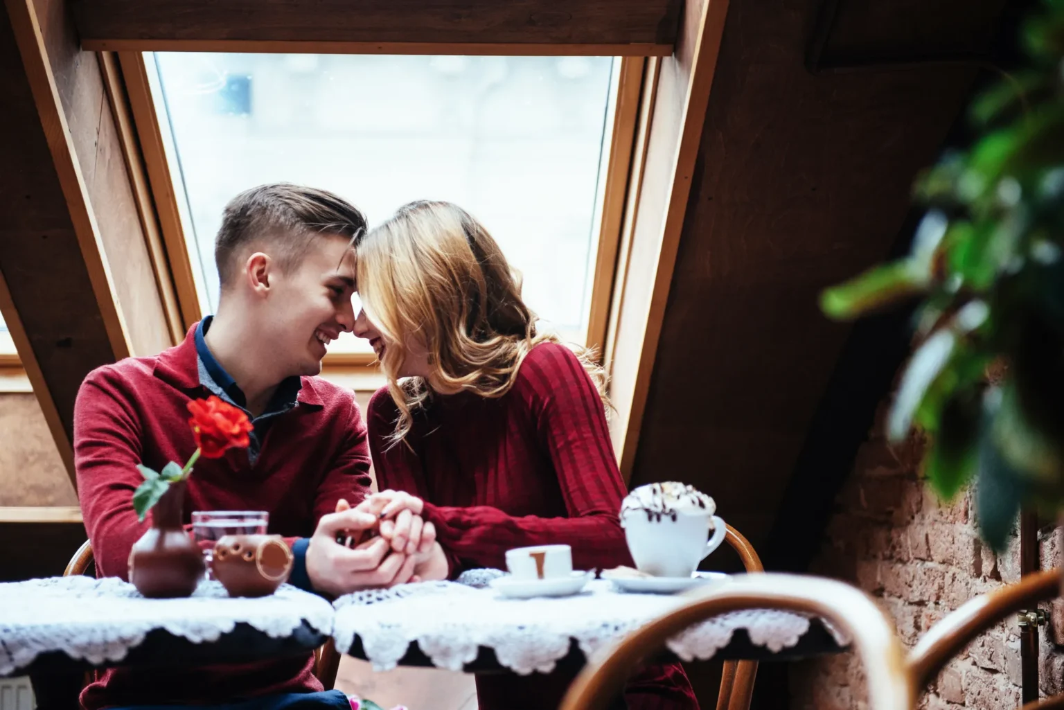 Couple sharing coffee at a café window