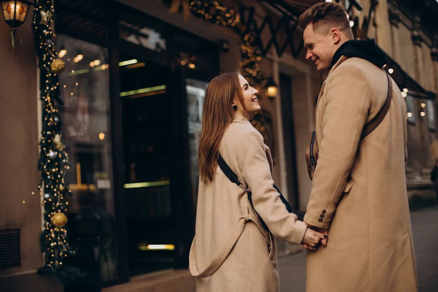 Couple walking together on a quiet Upper West Side street in winter.