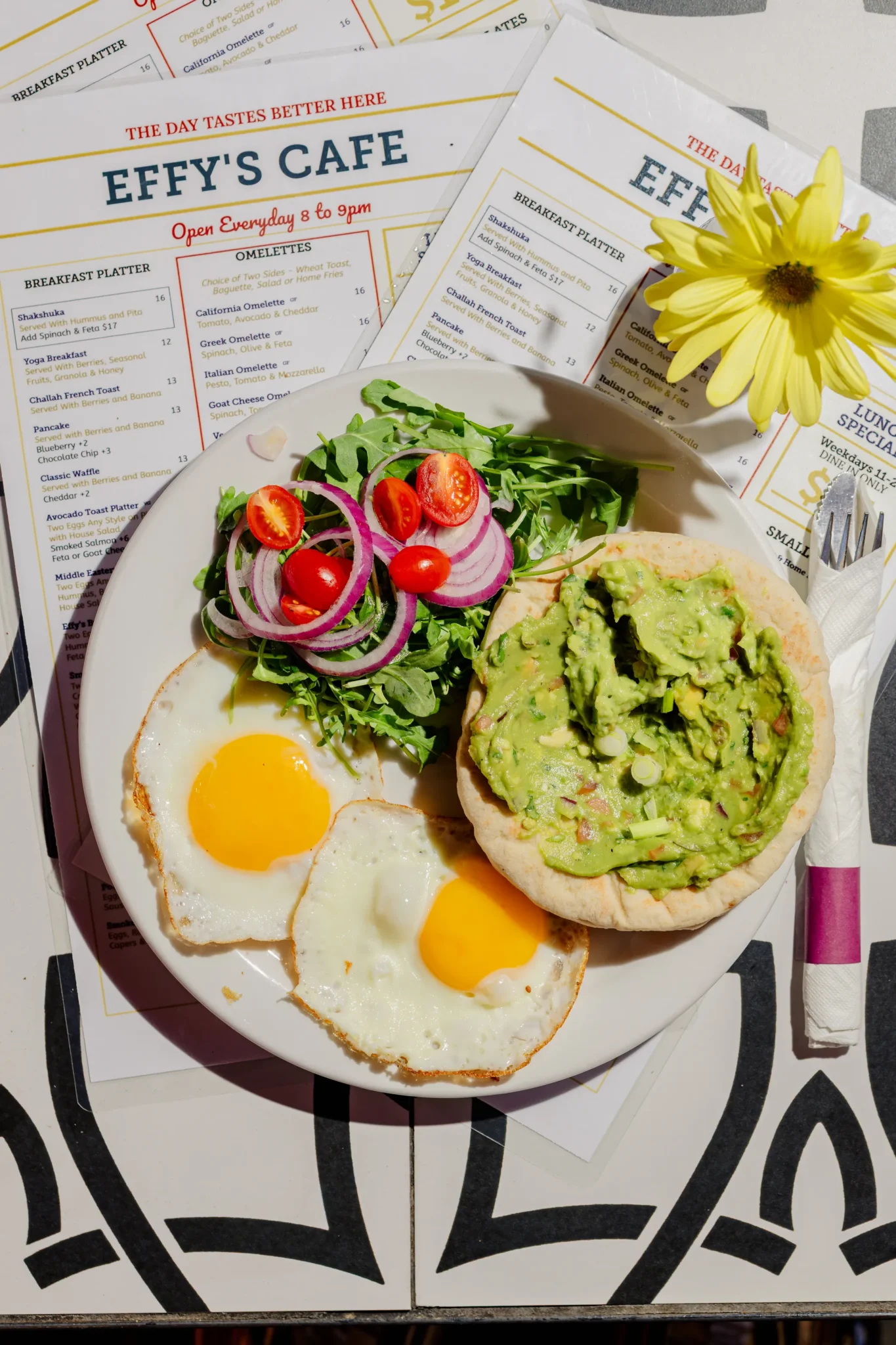 egetarian restaurant menu featuring wraps, salads, hummus, and shakshuka at a casual café