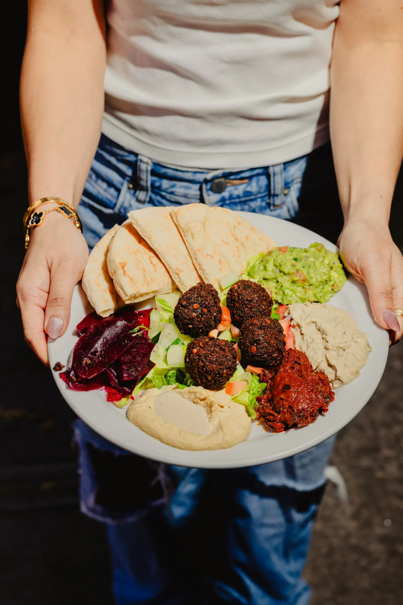 Scratch-made vegetarian dishes at Effy’s Café in NYC, including falafel platter and Tel Aviv salad